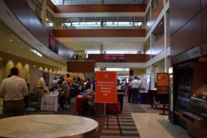 A sign at one end of the HSLC Atrium reads "Welcome to the BadgerConnect Research Services Fair"