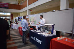 The Gilson representative talks with two BadgerConnect attendees.