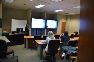 At the final Workshop Session, Xiao Zhang presents "Intro to Population Health Data Collection and Dissemination" in a conference room.