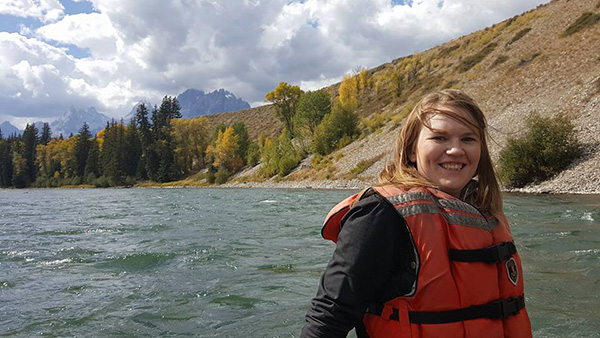 Ashley Weichmann with a body of water behind her.