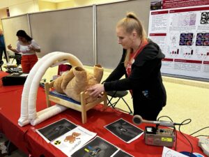 science expeditions - lauren doing demo with stuffed bear at booth