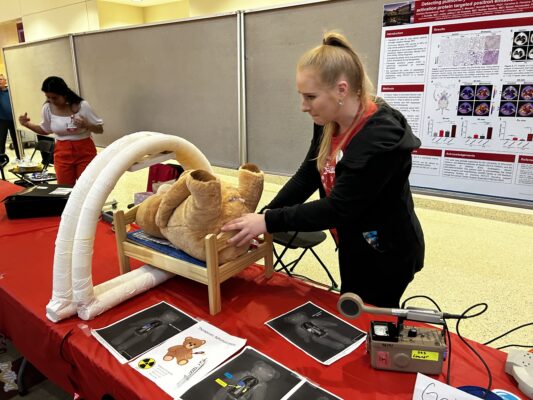science expeditions - lauren doing demo with stuffed bear at booth