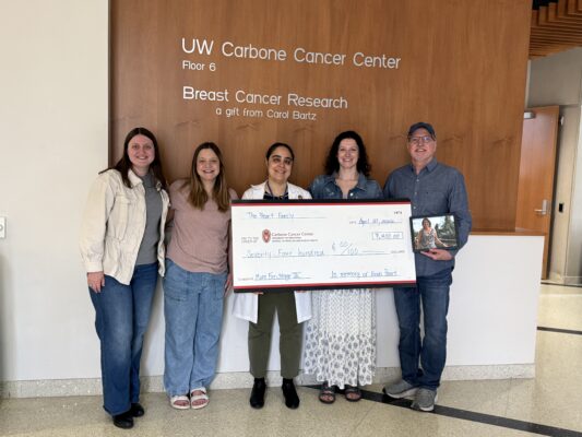 Photo of donors holding a large check