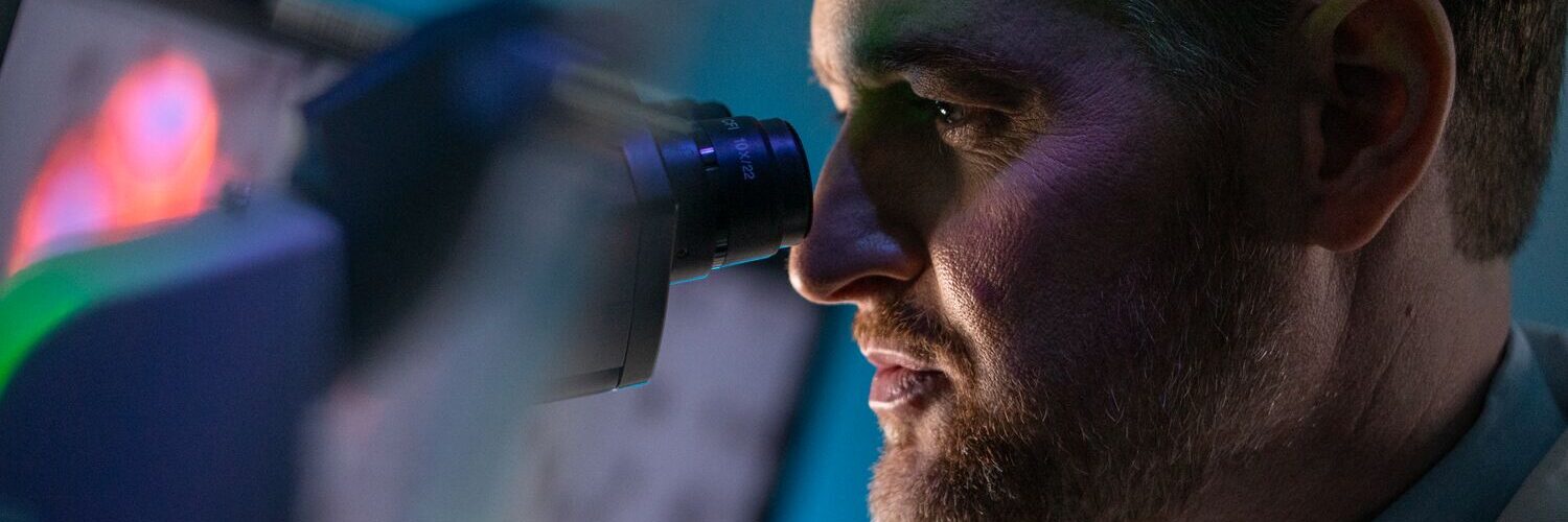 Dr. Lang looking through microscope