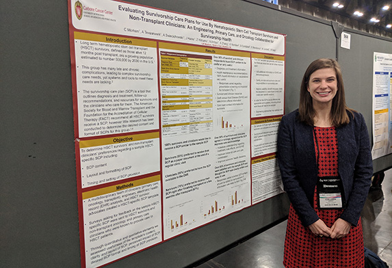 woman in front of research poster