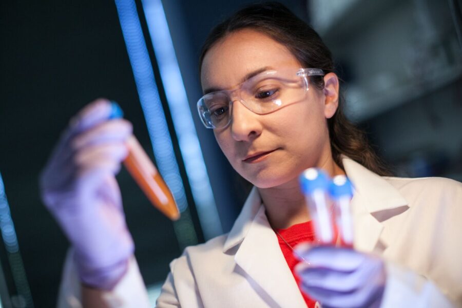 Woman looking at test tube in lab