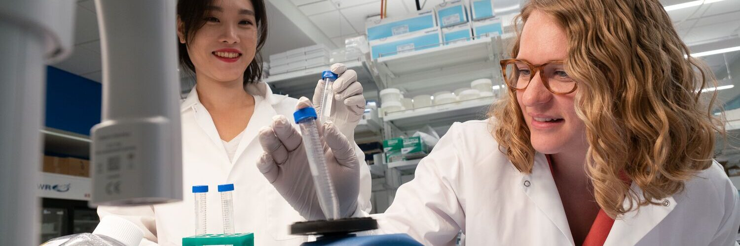 two women looking at test tubes