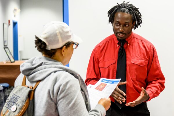 Man educating woman through outreach