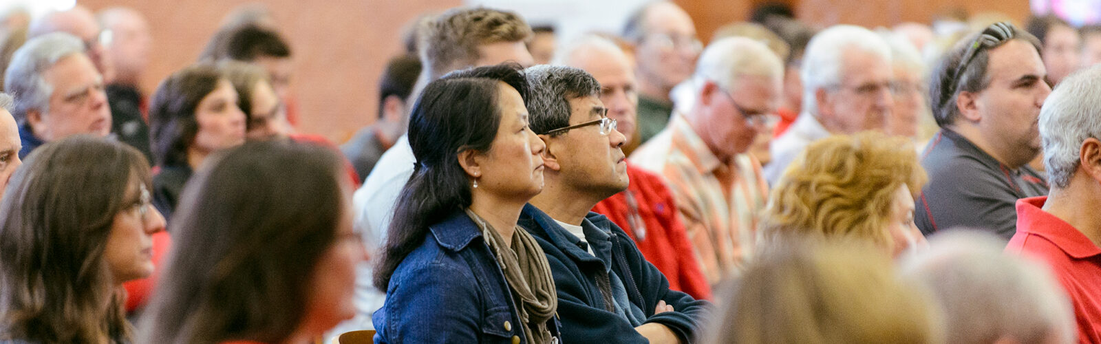 group of people listening to speech